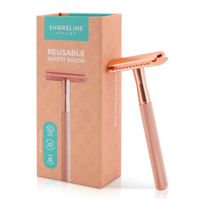 Rose Gold Safety Razor Leaning On Gift Box